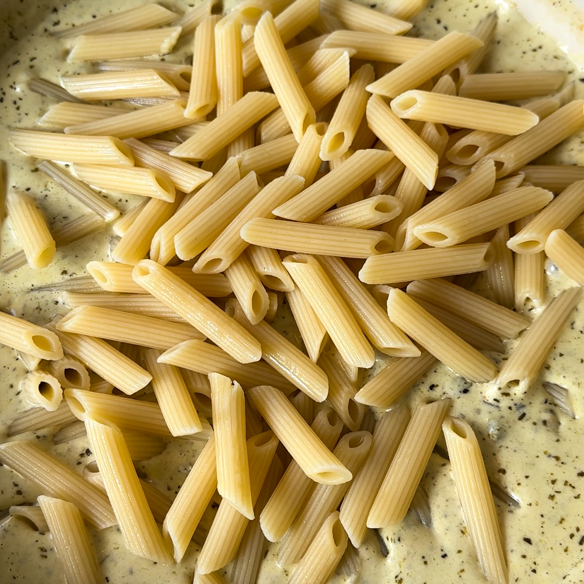 Let sauce thicken & add in aldente penne pasta!