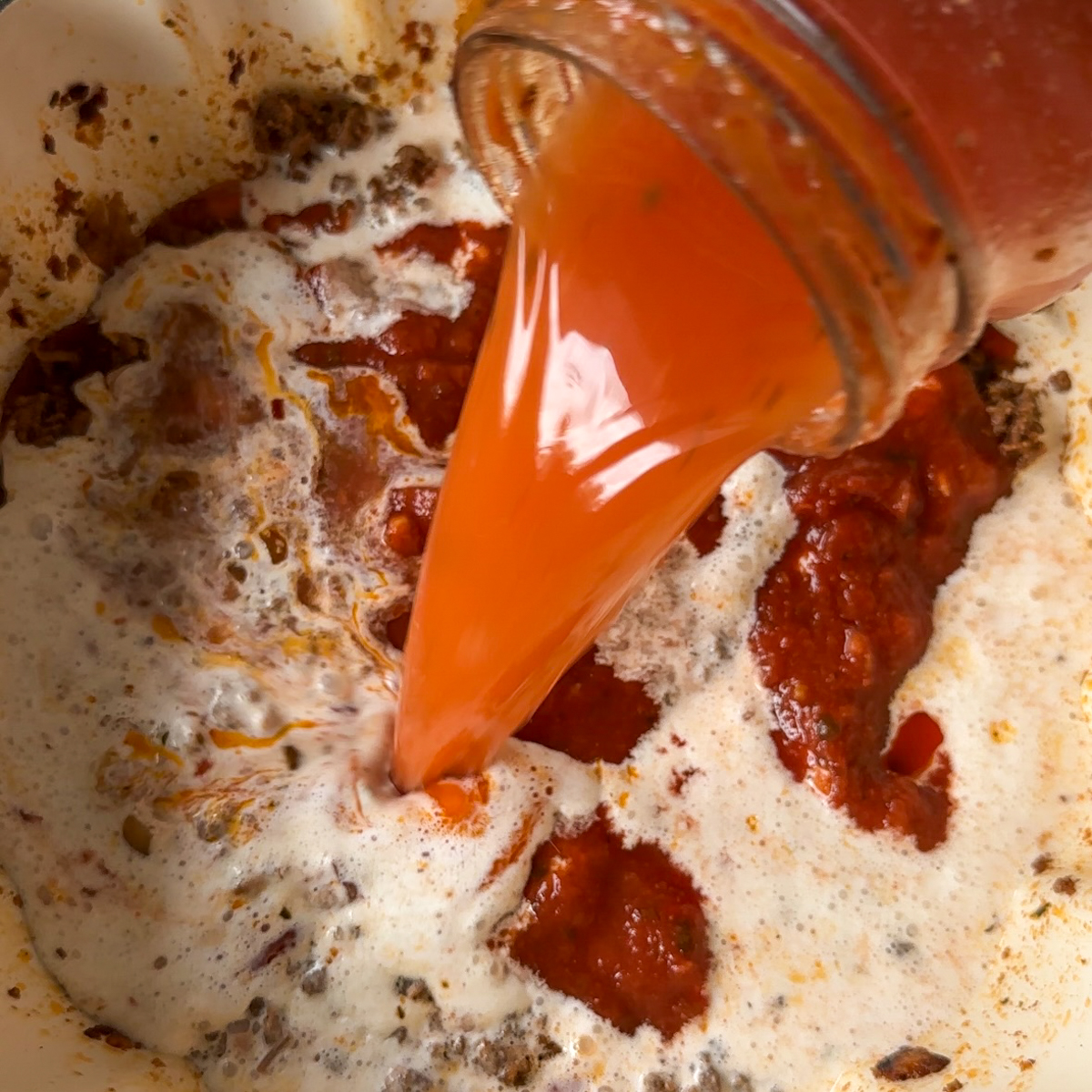 Add in tomato sauce, heavy cream & broth.