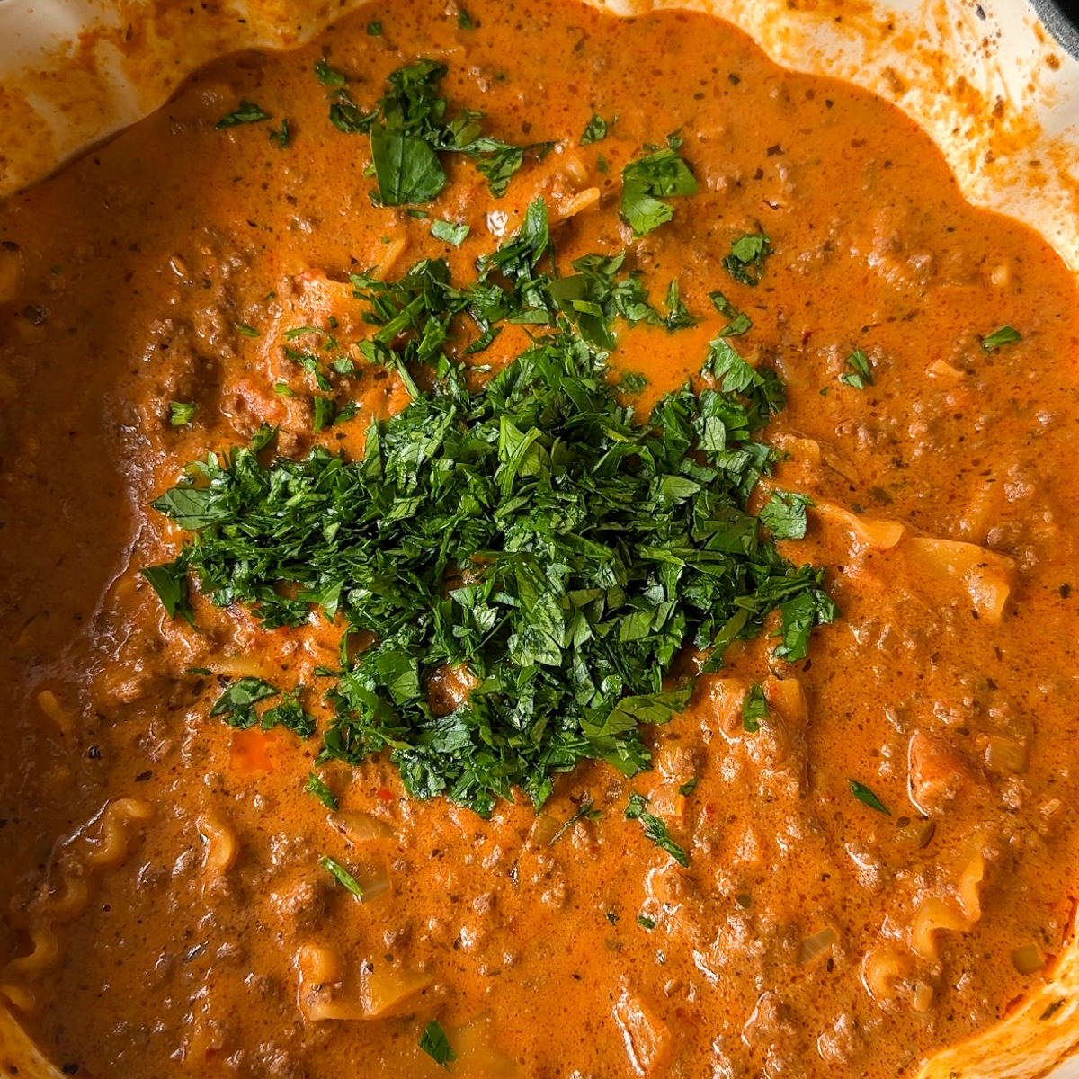 Finally, mix in lasagna sheets, parsley & cheese!