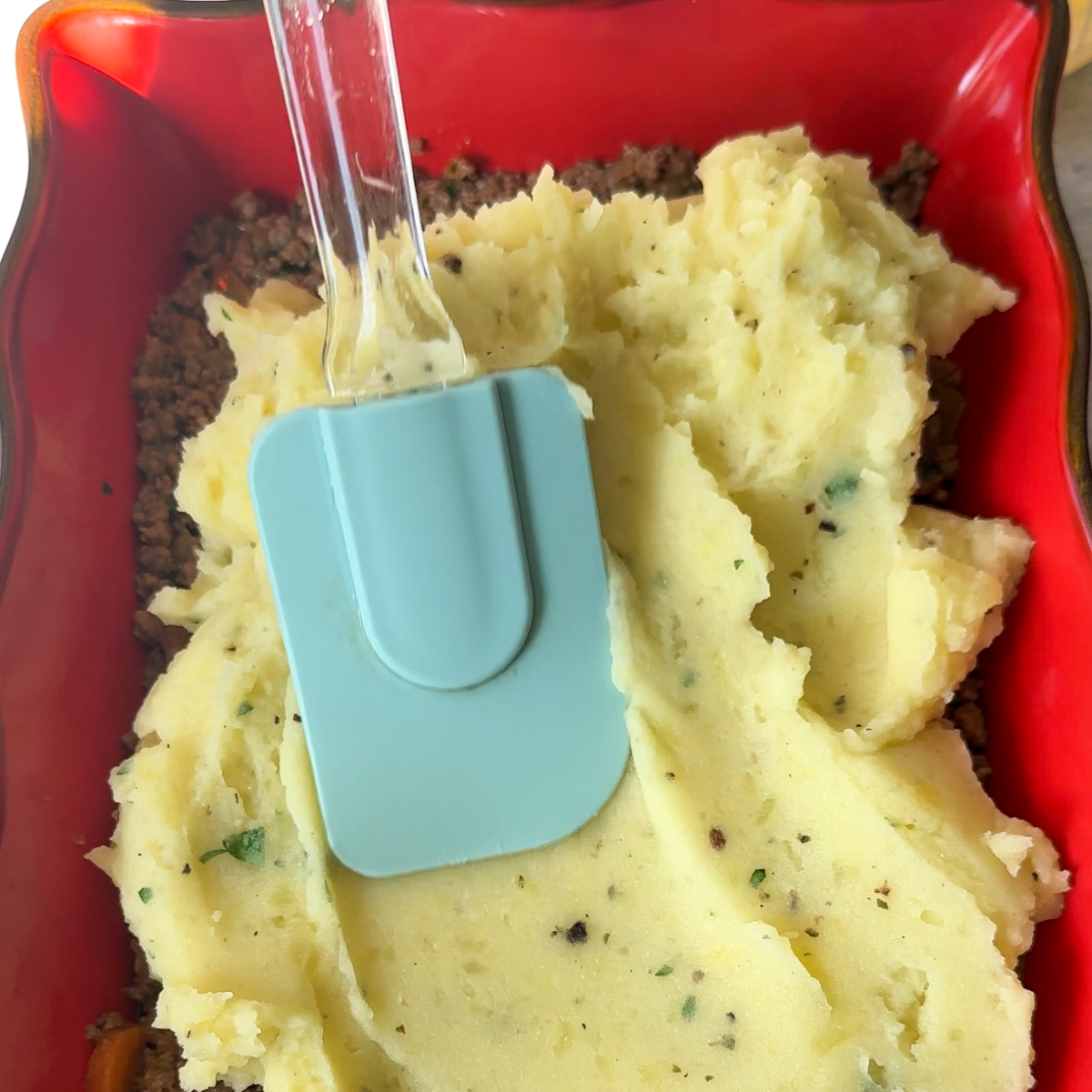 Layer the meat & mashed potatoes in a baking dish.