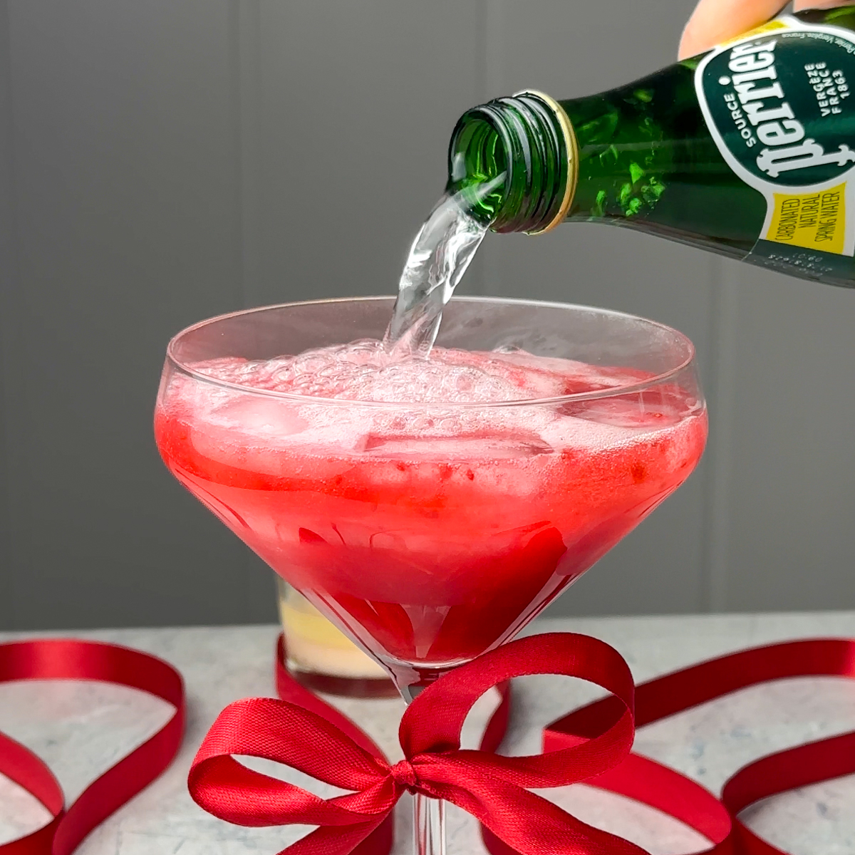 Transfer to a martini glass over ice with some sparkling water!