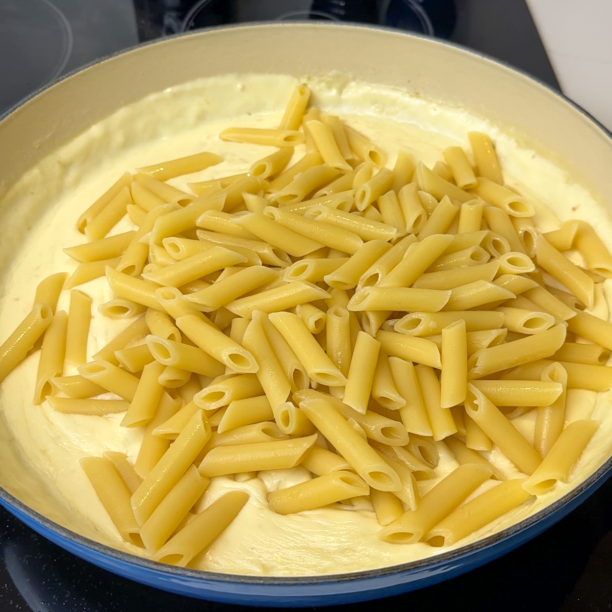 Add in the aldente penne pasta & mix well!