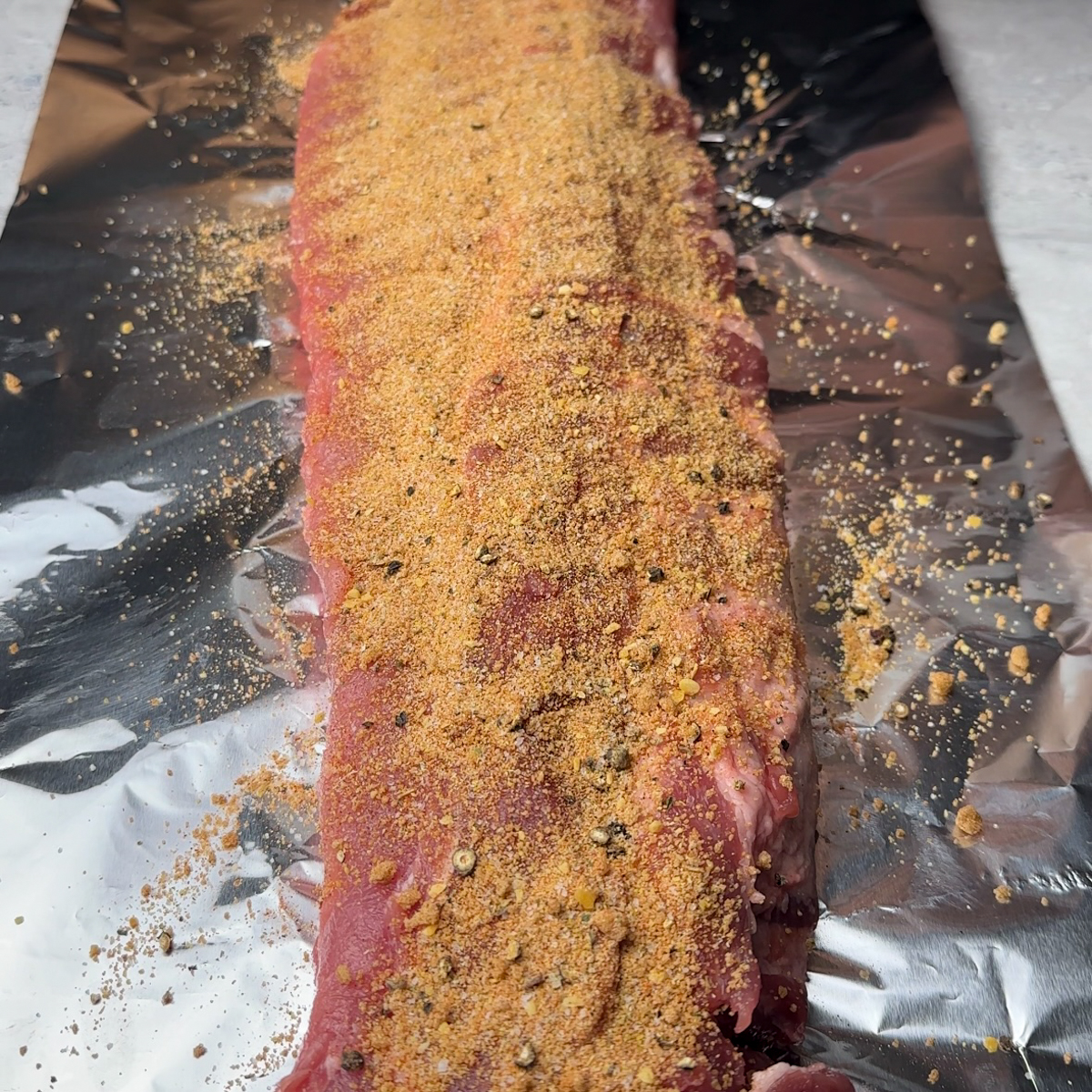 Add spice rub to the rib rack.