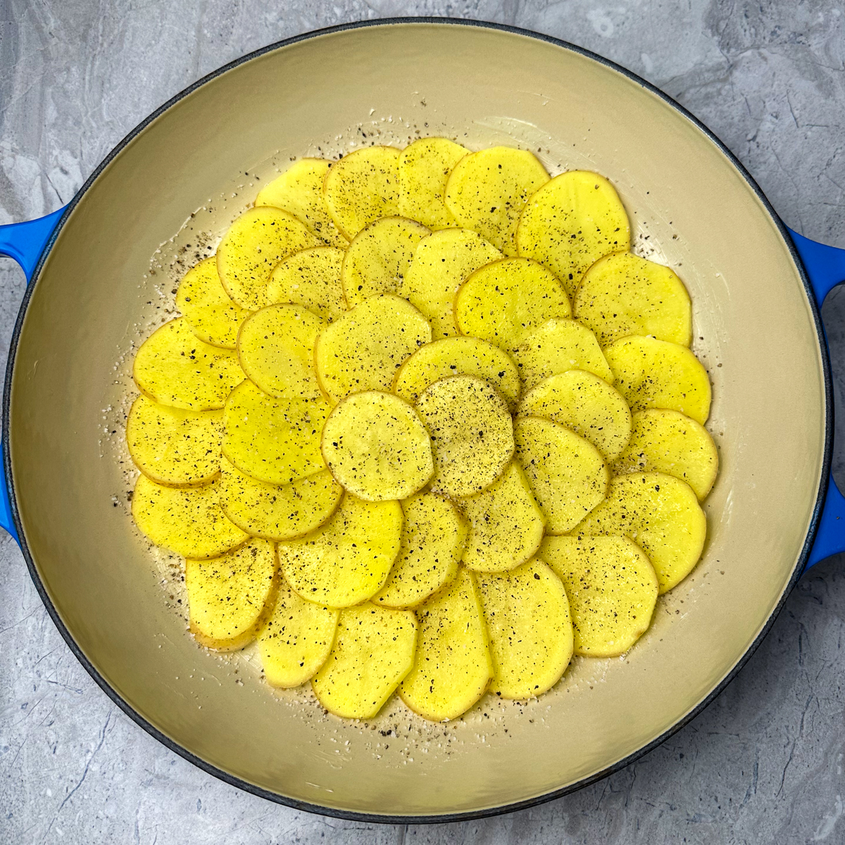 Layer the russet potatoes with salt & pepper