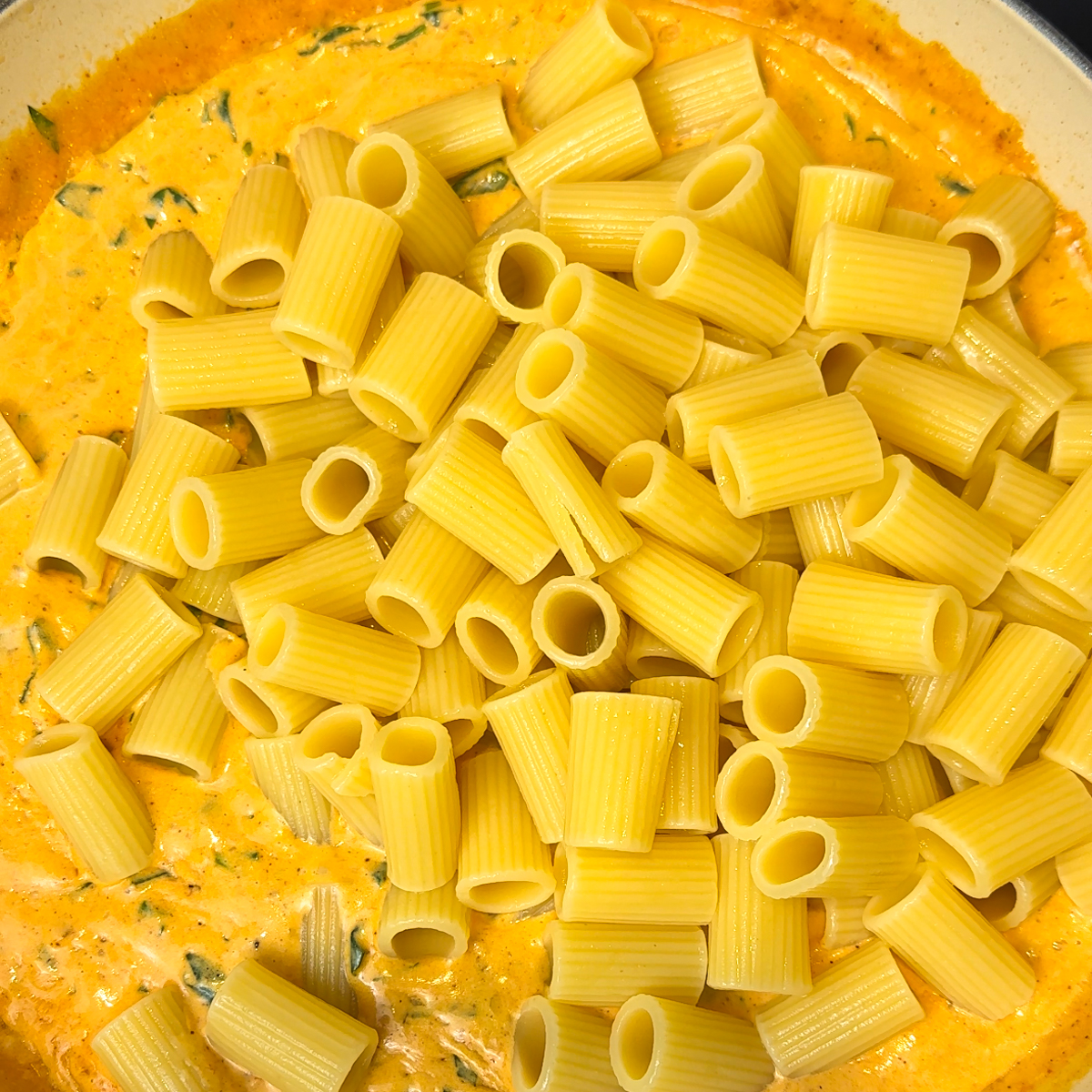 Add in the spices, spinach & pasta!