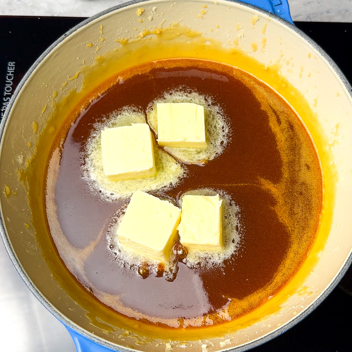 Once the sugar has melted, add in the butter & heavy cream!