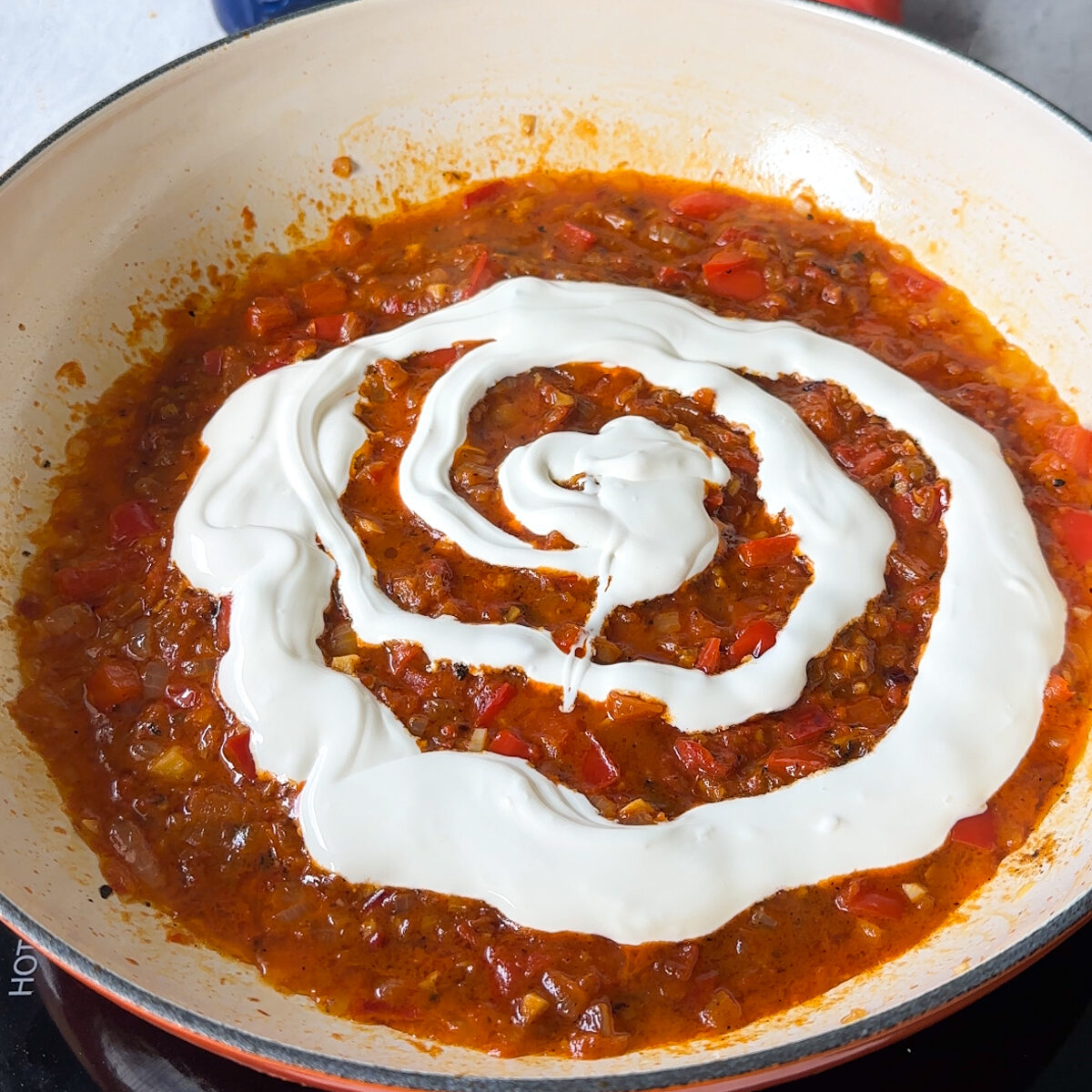 Add red pepper spread, pasta water & heavy cream!