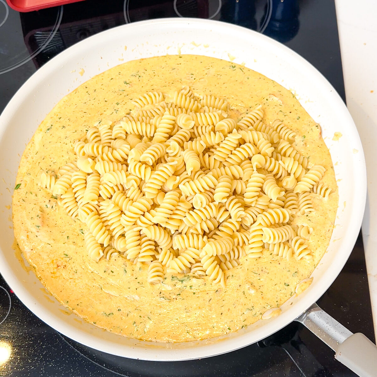 Add in the spices & the pasta, mix well!