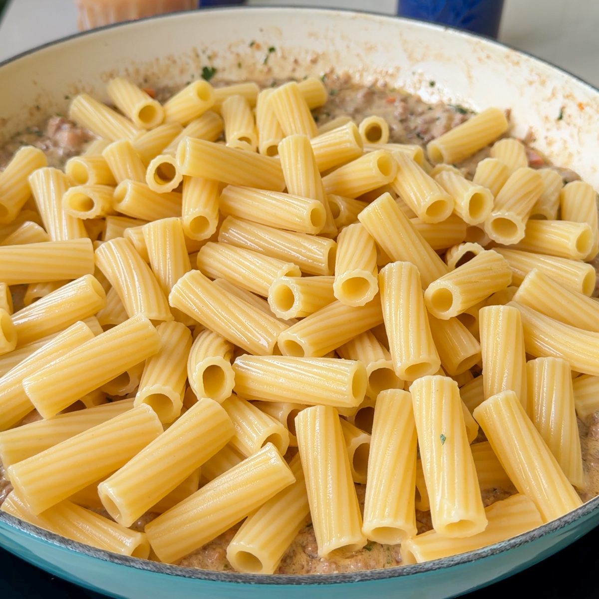 Once the sauce has thickened, add in the al dente rigatoni pasta!
