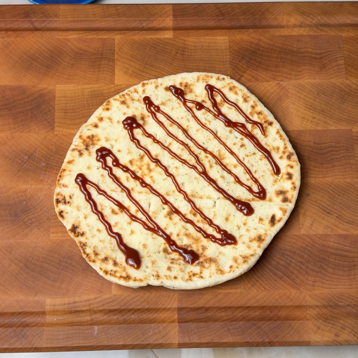 Add bbq sauce & tomato sauce as the base of the naan pizza!
