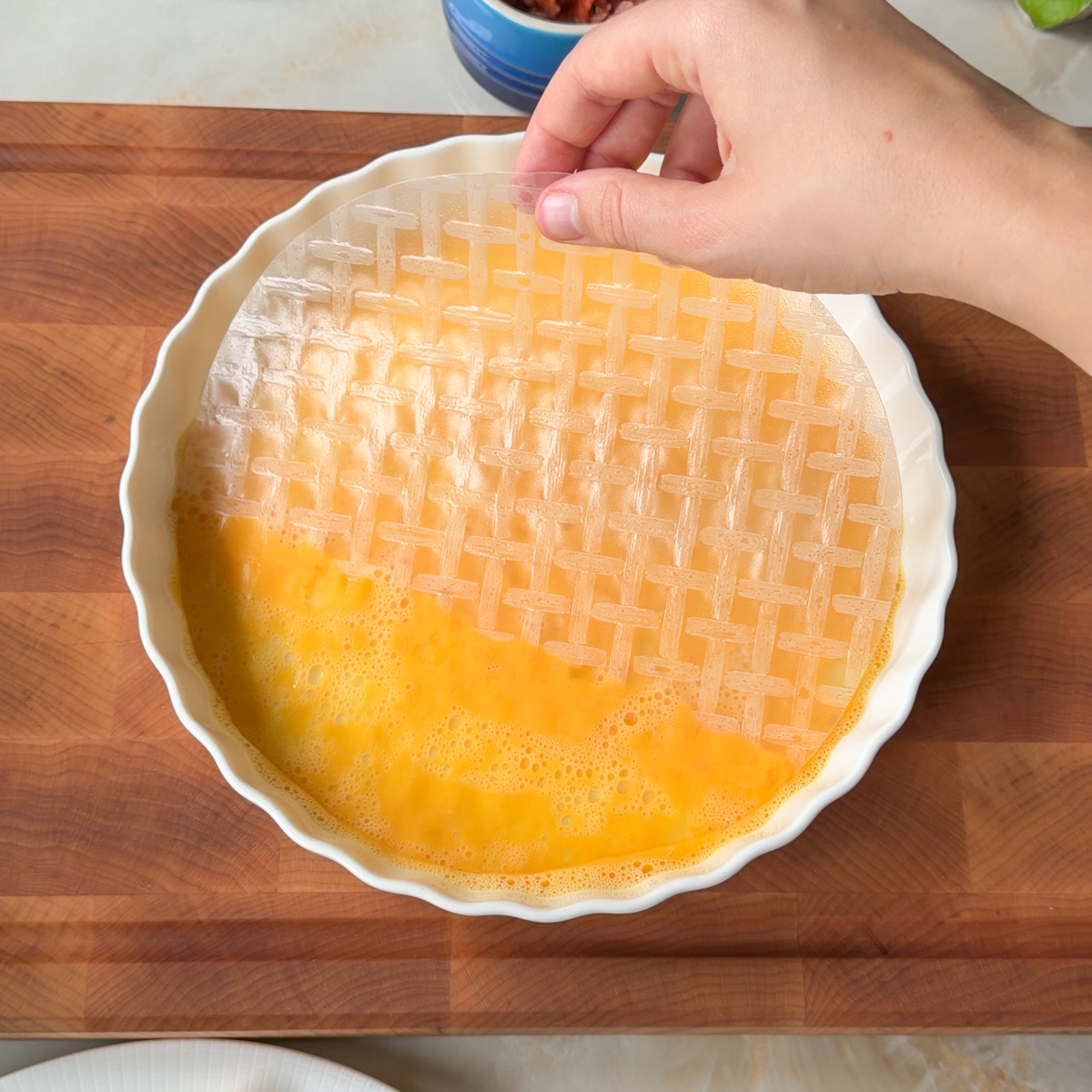 First, dip the rice paper into egg wash!