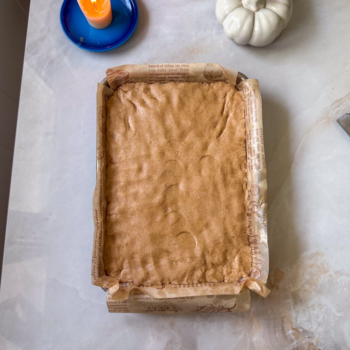 Press into the bottom of a lined baking tray!
