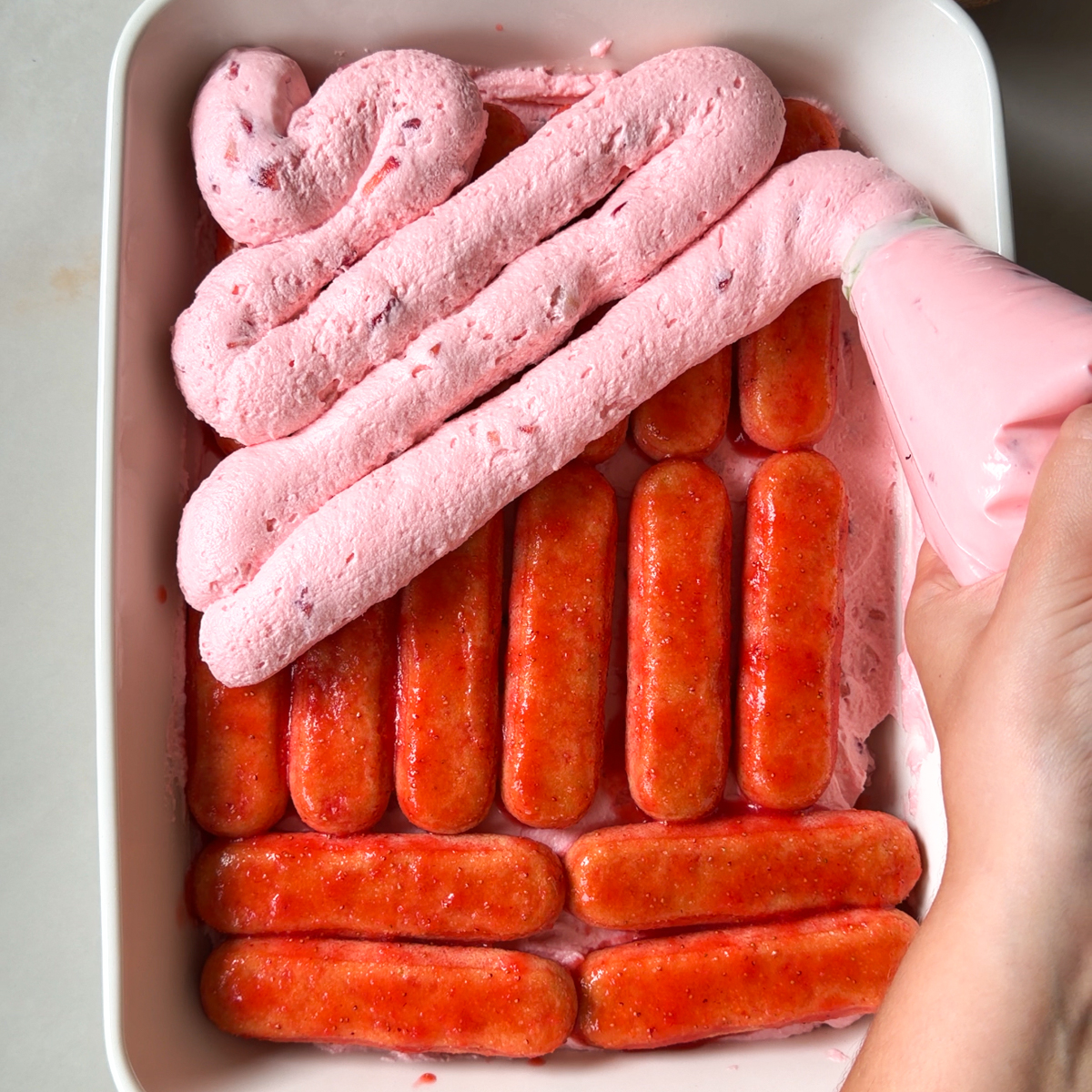 Arrange the ladyfingers & the strawberry cream cheese in a deep dish tray!