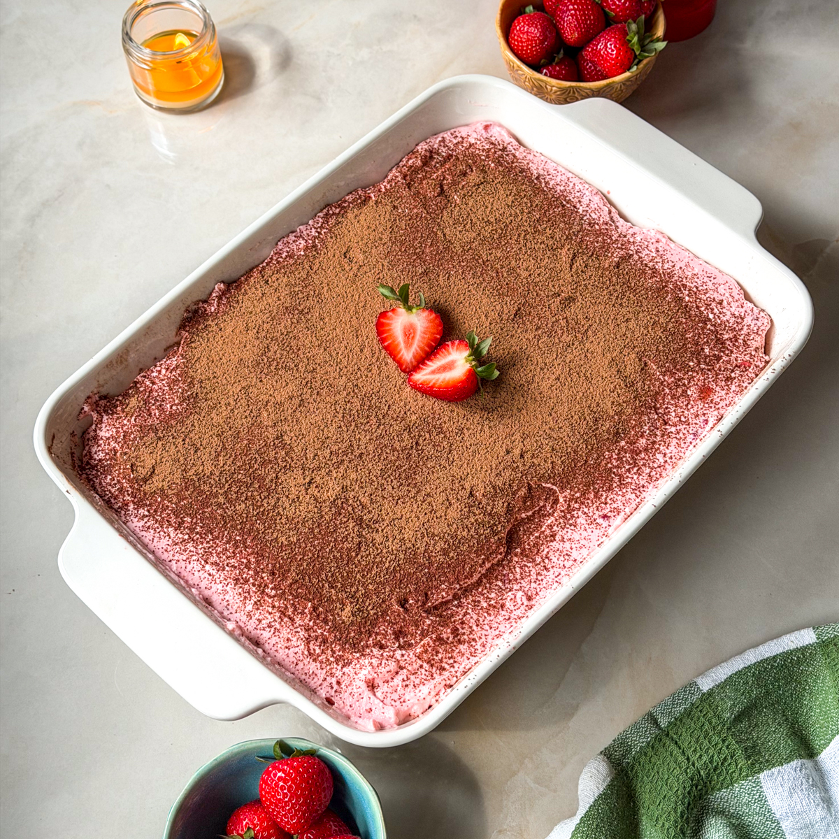 Top the strawberry tiramisu with cocoa powder & chill!