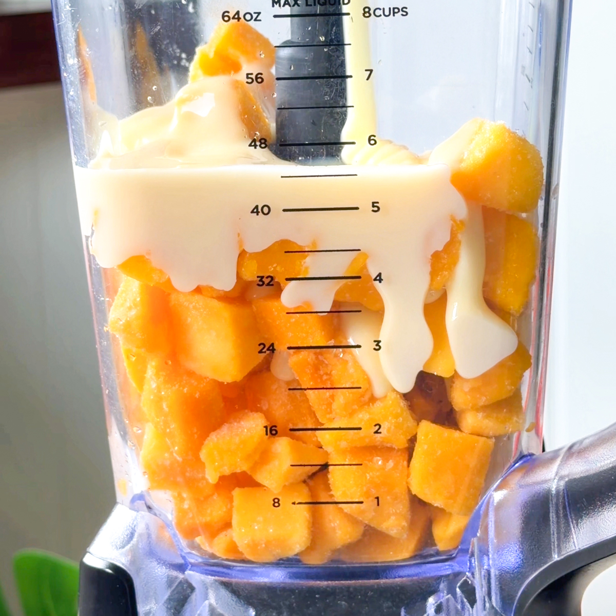 Blend the frozen mango chunks, condensed milk & water in a blender!
